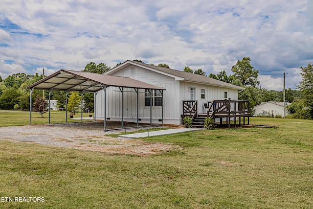 rear view of house featuring a carport, a wooden deck, and a lawn