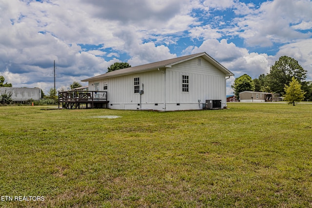 view of property exterior with a deck and a yard