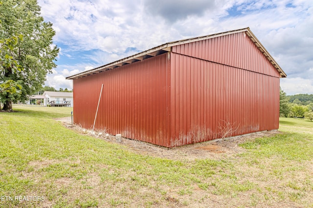 view of outbuilding with a lawn