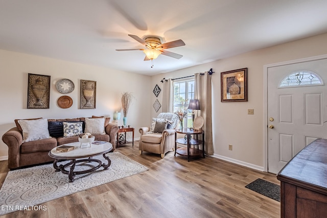 living room with light hardwood / wood-style flooring and ceiling fan