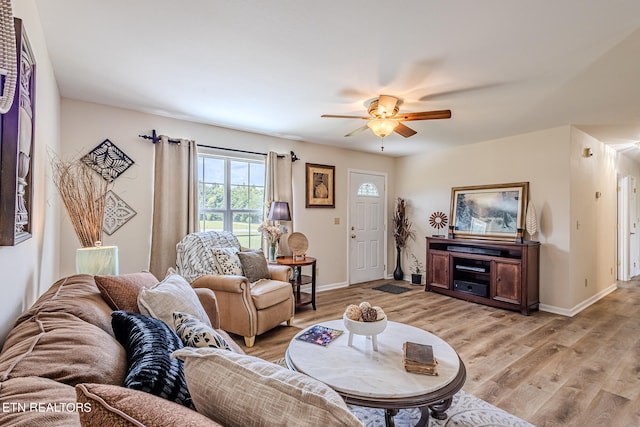 living room with light hardwood / wood-style floors and ceiling fan