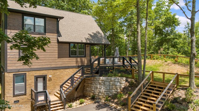 view of home's exterior with a wooden deck