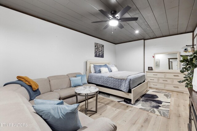 bedroom with ceiling fan, light wood-type flooring, and wooden ceiling