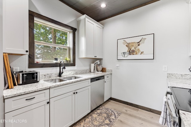 kitchen featuring light stone counters, light hardwood / wood-style floors, white cabinetry, appliances with stainless steel finishes, and sink