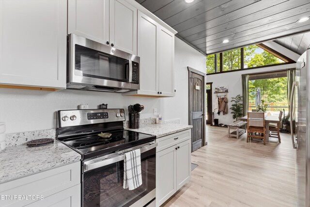 kitchen featuring light stone counters, stainless steel appliances, light hardwood / wood-style floors, wood ceiling, and white cabinets