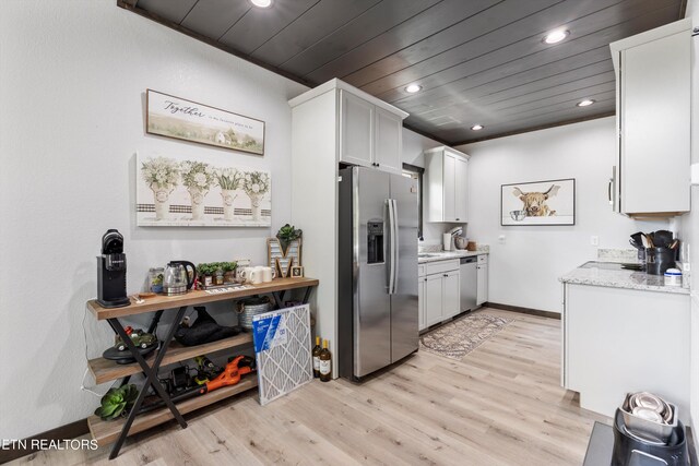 kitchen with wooden ceiling, appliances with stainless steel finishes, light wood-type flooring, light stone counters, and white cabinets