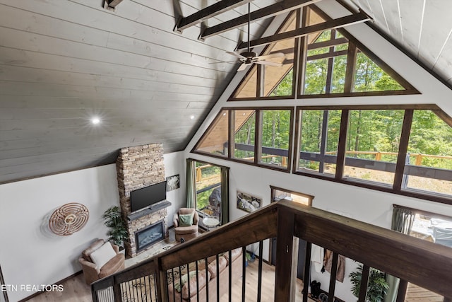 interior space featuring wood-type flooring, wooden ceiling, and lofted ceiling with beams