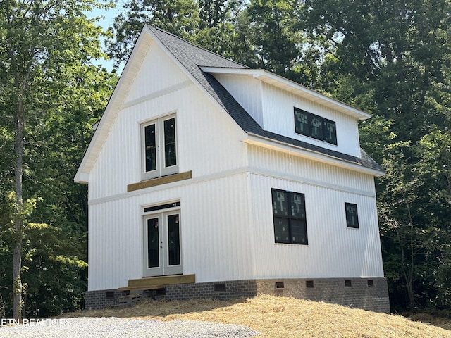 view of property exterior featuring entry steps, crawl space, roof with shingles, and french doors