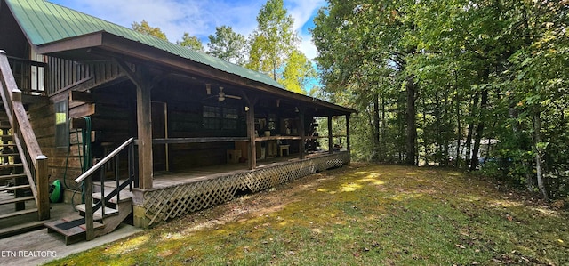 view of property exterior featuring a wooden deck and a yard