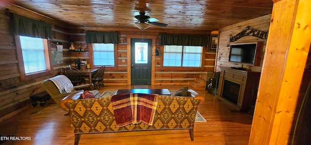 living room featuring ceiling fan, wood ceiling, and wood-type flooring