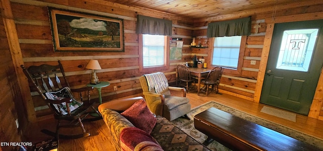 sitting room with wood ceiling, hardwood / wood-style flooring, and wooden walls