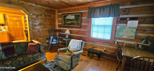 sitting room featuring wooden ceiling, light hardwood / wood-style flooring, and wood walls