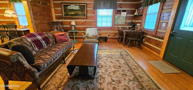 living room featuring wooden walls and light hardwood / wood-style flooring