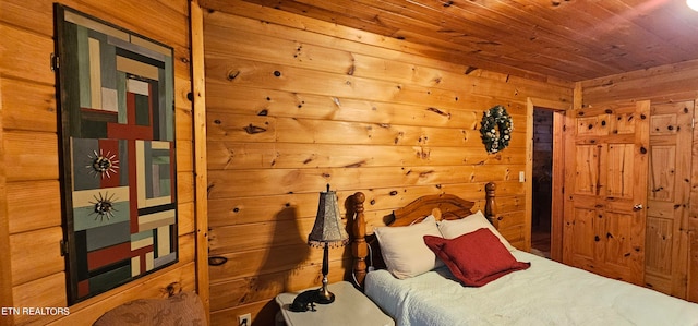 bedroom with wood ceiling and wood walls