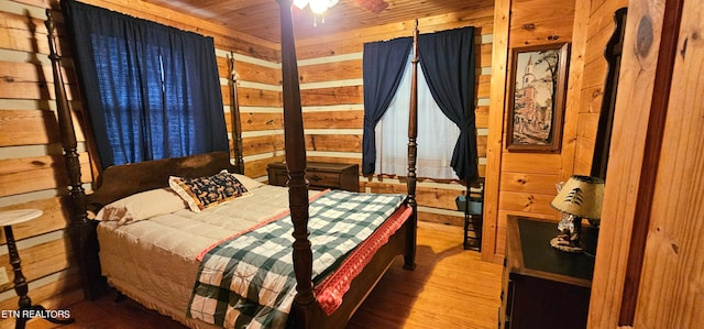 bedroom with wood-type flooring, wood walls, and wood ceiling