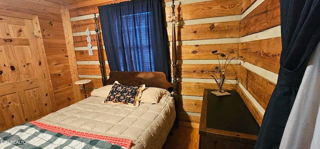 bedroom featuring wooden walls