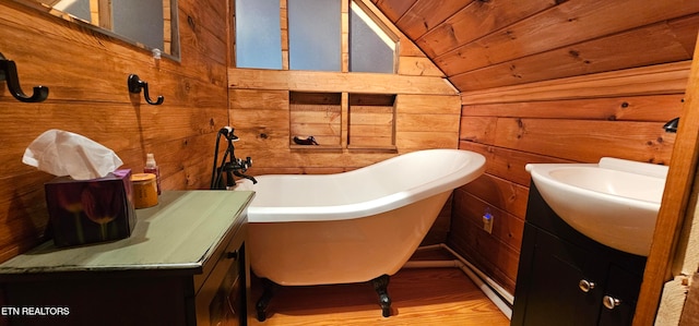 bathroom with vanity, a tub, wood ceiling, and wood walls