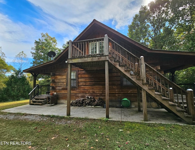 rear view of property with a lawn and a patio area