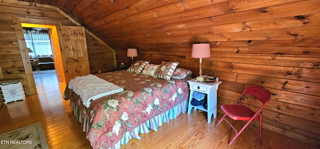 bedroom with wooden ceiling, vaulted ceiling, and hardwood / wood-style flooring