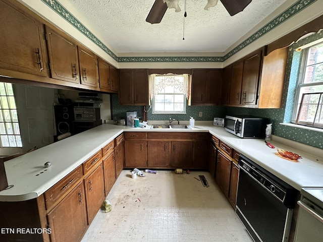 kitchen with ceiling fan, sink, a textured ceiling, and black dishwasher