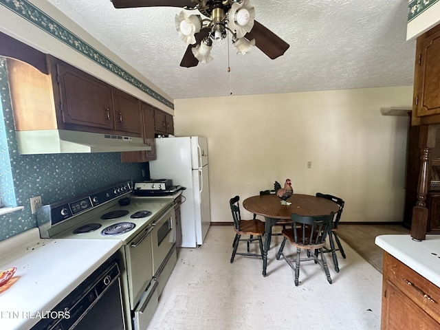 kitchen featuring ceiling fan, double oven range, a textured ceiling, and white fridge