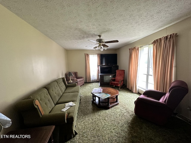 living room with carpet, a healthy amount of sunlight, and a textured ceiling