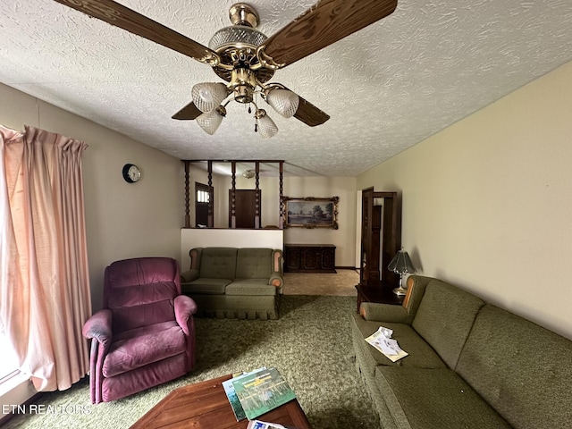 carpeted living room with ceiling fan and a textured ceiling