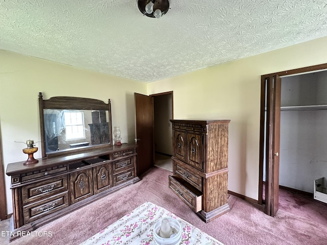 bedroom with light colored carpet, a closet, and a textured ceiling