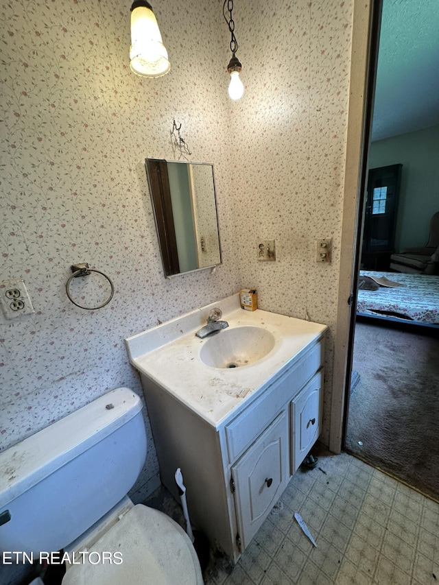 bathroom featuring toilet and vanity