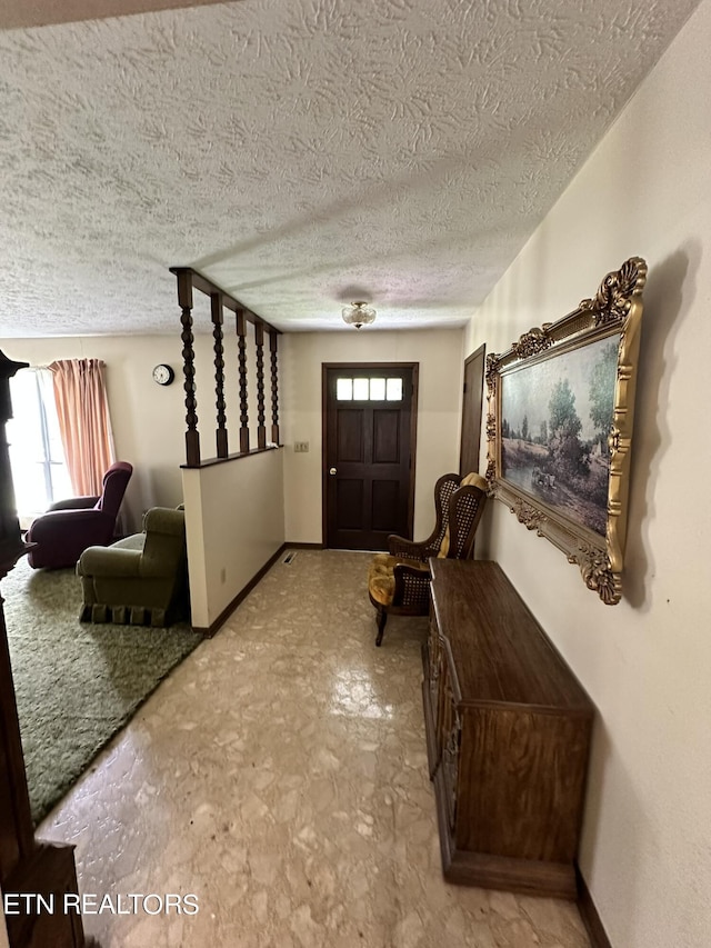 foyer with a healthy amount of sunlight and a textured ceiling