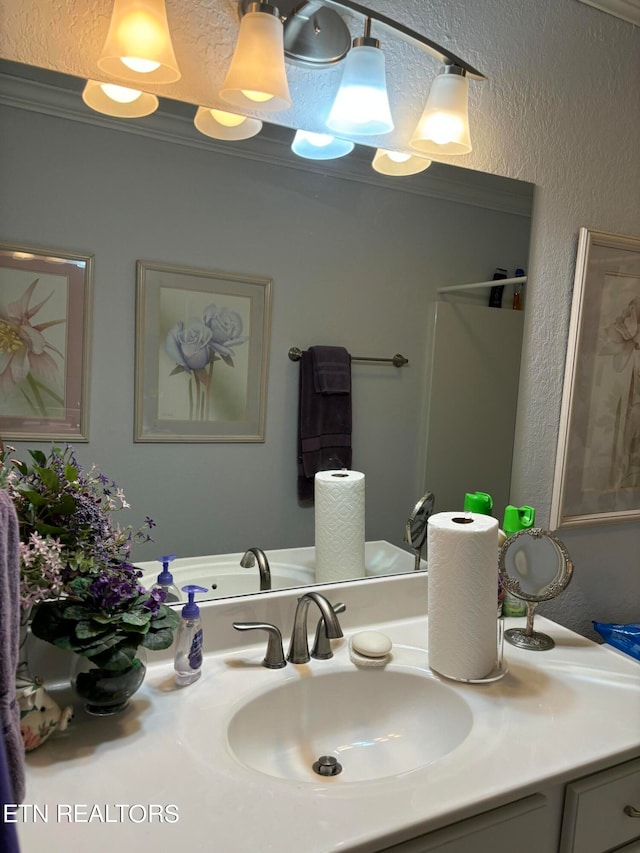 bathroom with vanity and crown molding