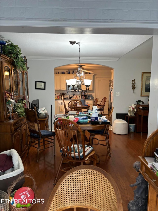 dining room with hardwood / wood-style flooring, a notable chandelier, and ornamental molding