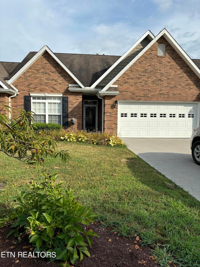 view of front of property with a garage and a front yard