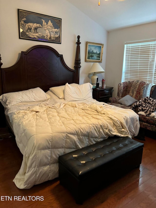 bedroom featuring dark hardwood / wood-style floors and vaulted ceiling