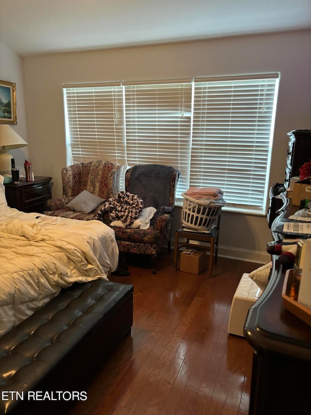 bedroom with dark hardwood / wood-style flooring