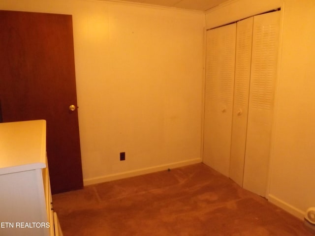 unfurnished bedroom with a closet and carpet floors