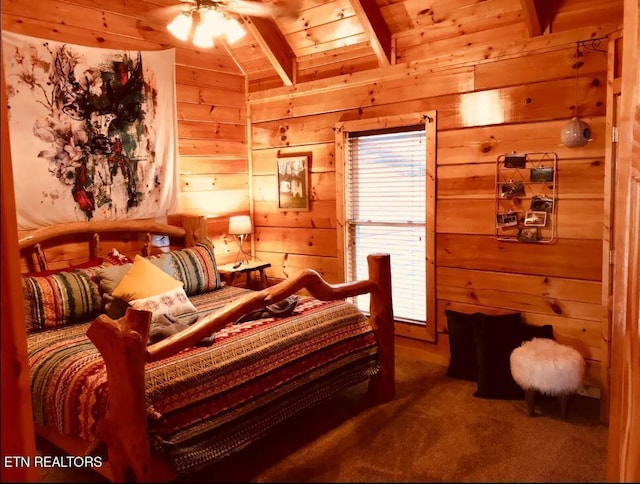 bedroom featuring multiple windows, beam ceiling, wooden walls, and carpet floors