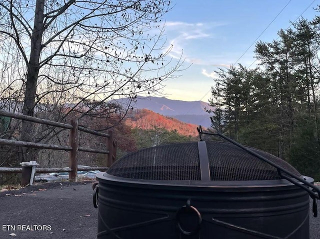 yard at dusk featuring a mountain view