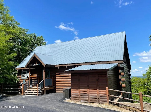 log cabin featuring an outbuilding