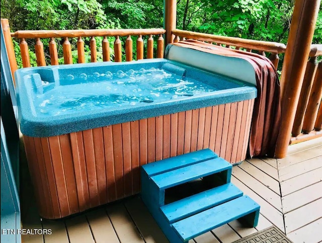 wooden deck with a hot tub