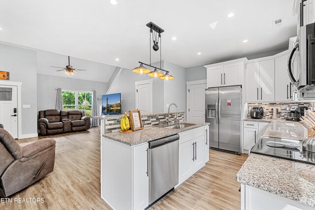 kitchen with stainless steel appliances, decorative light fixtures, sink, and white cabinets