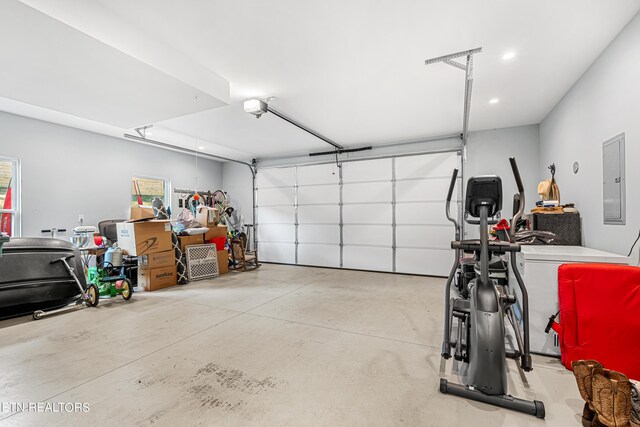 garage with a garage door opener and electric panel