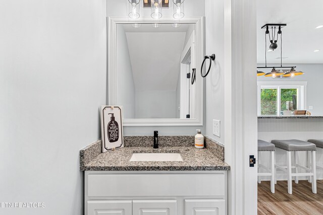 bathroom featuring vanity and hardwood / wood-style flooring