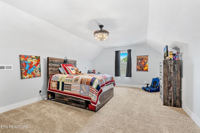 bedroom featuring vaulted ceiling and carpet