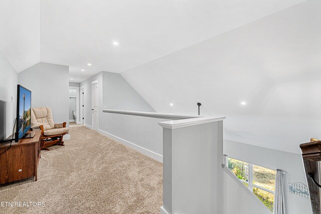 sitting room with lofted ceiling and light colored carpet