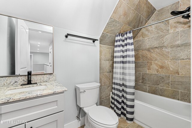 full bathroom with vanity, shower / tub combo with curtain, and toilet