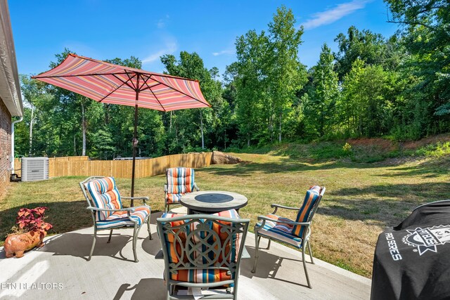 view of patio / terrace with central AC and an outdoor fire pit