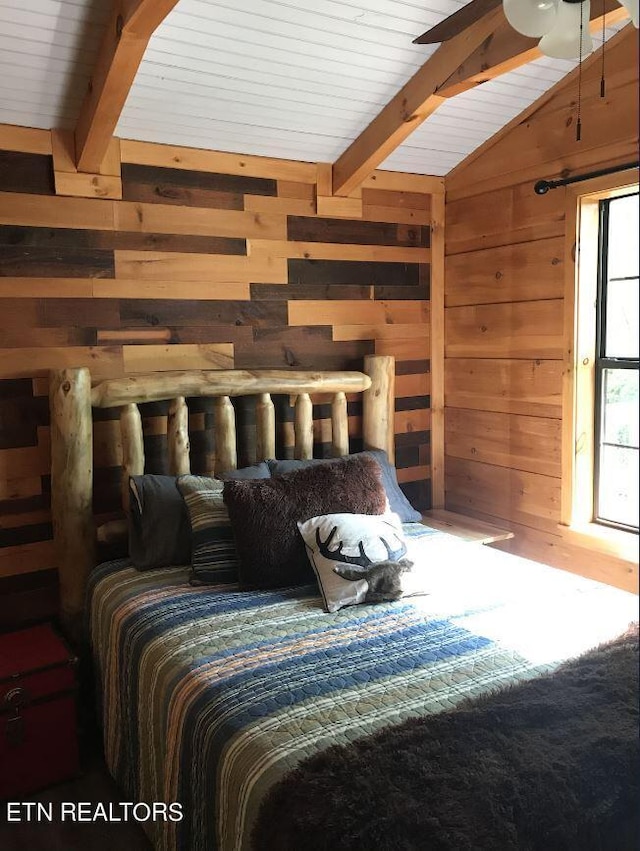 bedroom with wood ceiling, lofted ceiling with beams, and wood walls