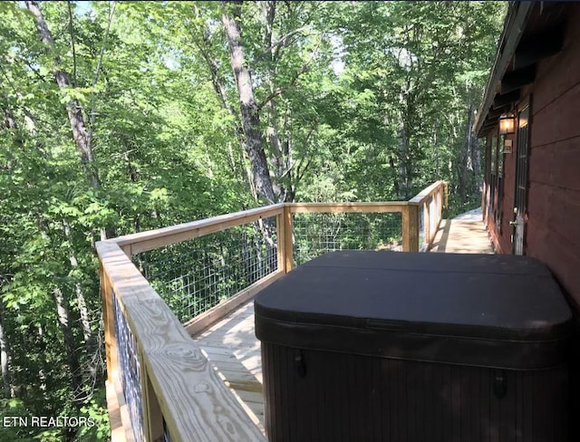 wooden terrace with a hot tub