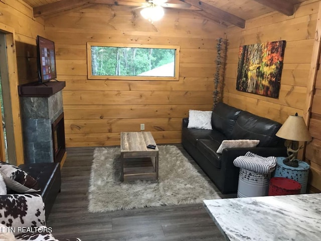 living room with wooden walls, lofted ceiling with beams, dark hardwood / wood-style floors, and wooden ceiling